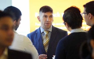 A recruiter speaks with students
