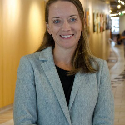 Rachel Rutkoski smiles proudly, representing a student success story after earning her Doctor of Professional Studies in Information Management.