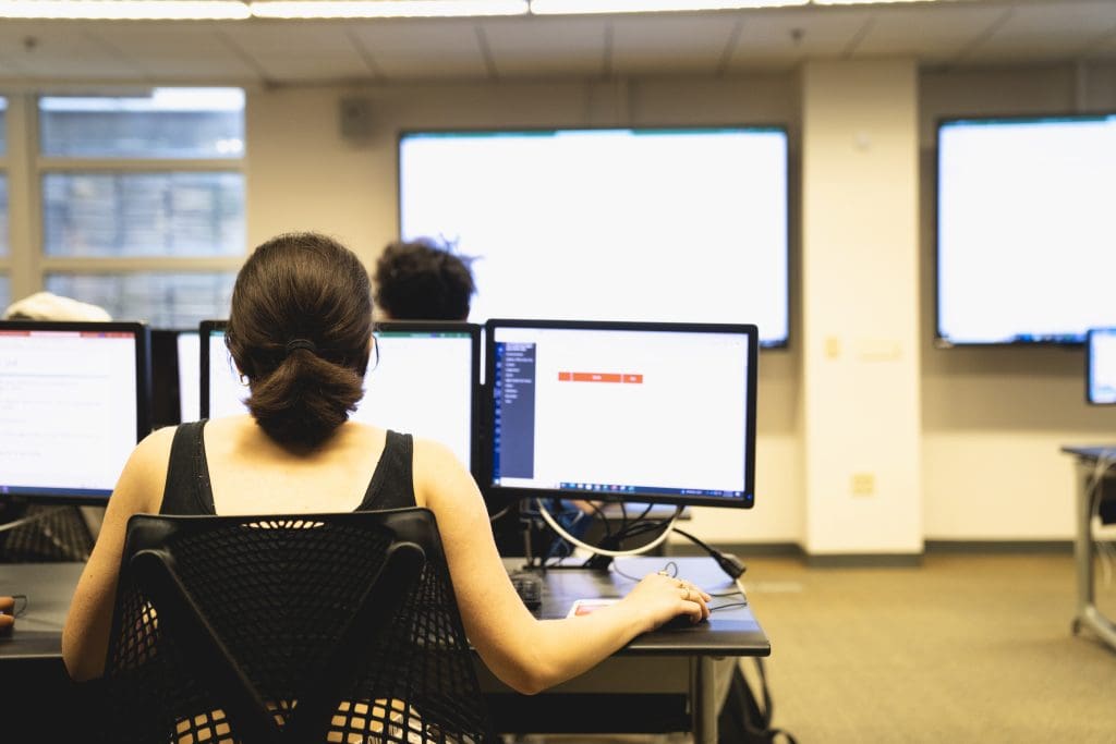 young woman sitting at computer in class